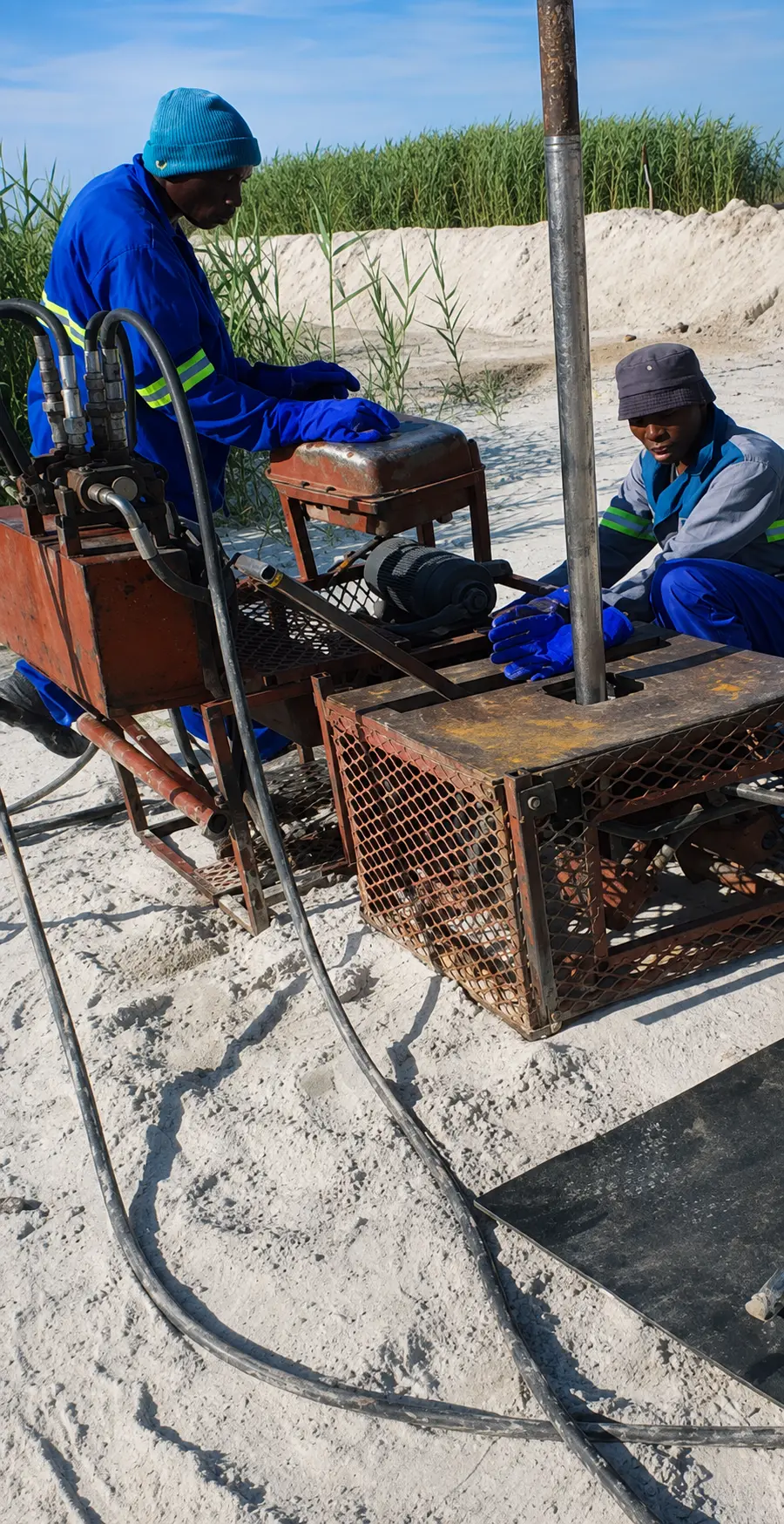 Ukwazi crew operating grouting solutions equipment at a tailings storage facility